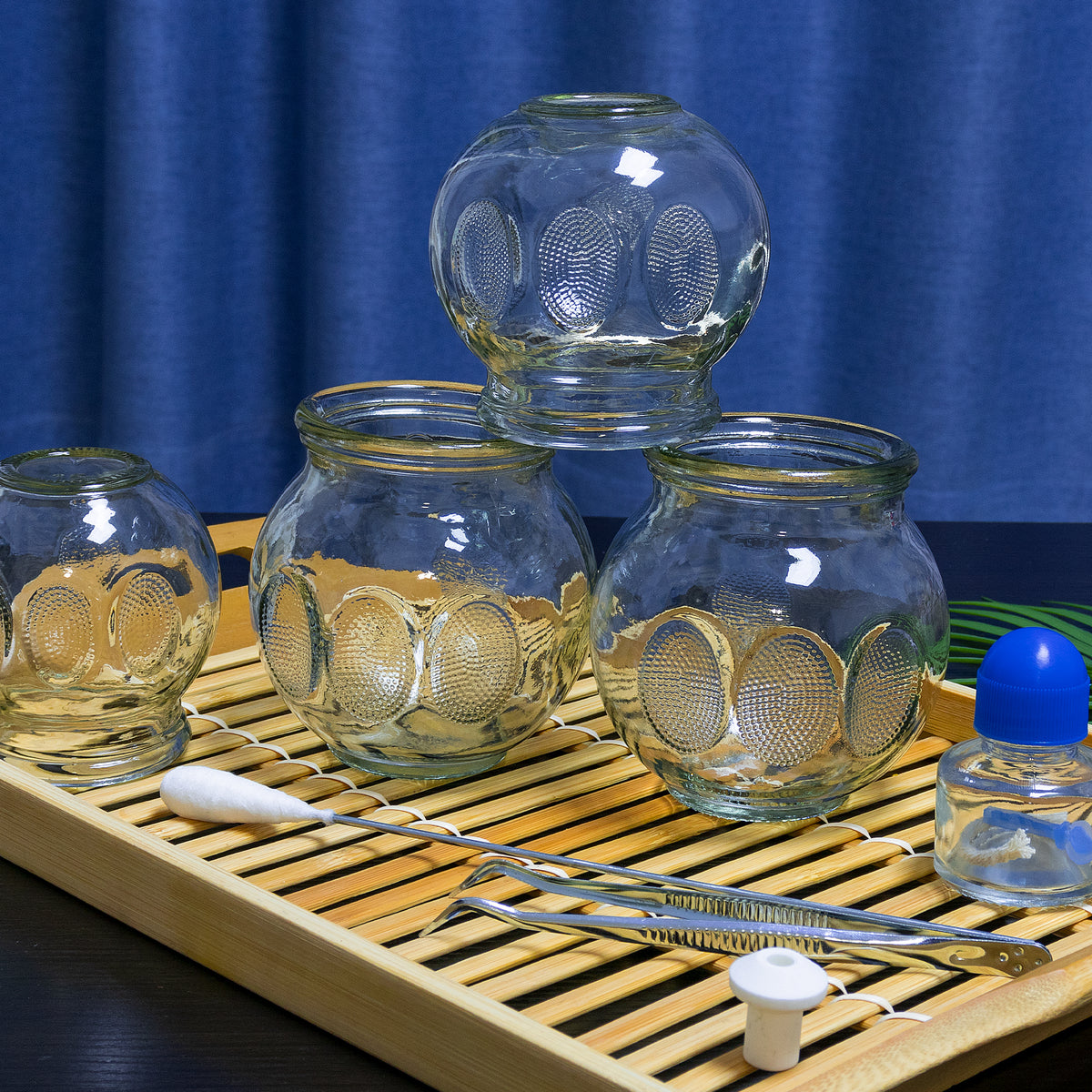 Ten-Chi glass cupping therapy set — high-quality glass cups on tray with blue background